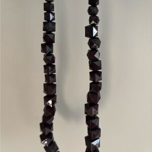 Purple, faceted bead and black gros grain ribbon necklace.